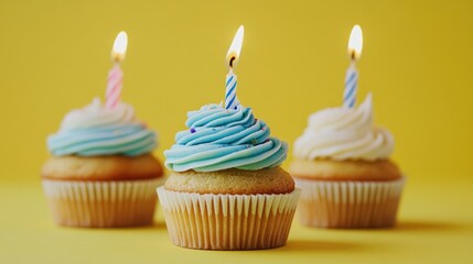 Tasty Birthday Cupcakes with Lit Candles on Yellow Background