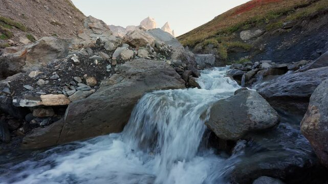 Landscape of Aiguilles d Arves of rugged rocky mountain peak and cascade flowing during autumn in Maurienne Valley at France