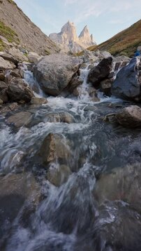 Landscape of Aiguilles d Arves of rugged rocky mountain peak and cascade flowing during autumn in Maurienne Valley at France