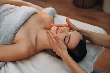 Papier peint photo intissé Close up view, facial massage. Relaxed young woman getting massage by therapist in spa salon