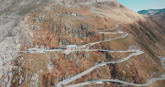 Aerial view of the Furka Pass in the Swiss Alps. Winding roads, steep cliffs and the historic Hotel Belv&eacute;d&egrave;re make for an adventurous journey through this unique landscape.