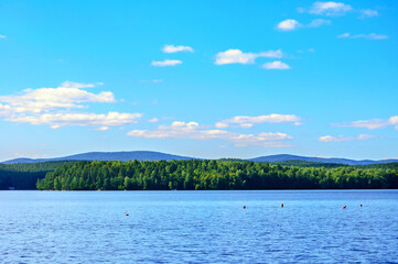 Summer water landscape, summer view of the Spruce Lake or Elovoe lake in Southern Urals in sunny summer afternoon