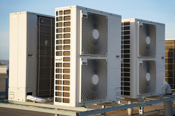 Powerful industrial air conditioning or heat pump outdoor units with two fans, ecological green energy source of heat or cold concept