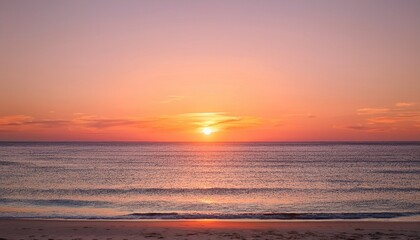 Fototapeta premium Tranquil minimalist beach sunset scene as the sun dips below the horizon, leaving behind a soft, beautiful gradient of orange and pink in the sky
