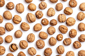 A Plethora of Whole Walnuts Scattered on a Clean, White Surface, Ready to Eat