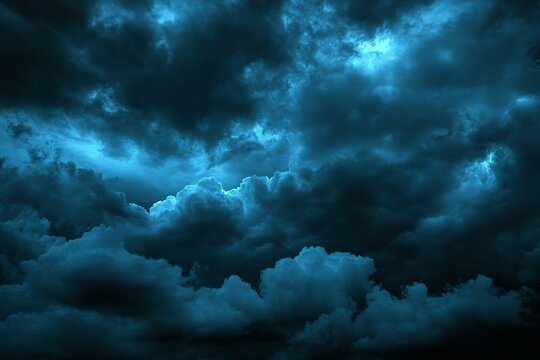 Black dark greenish blue dramatic night sky. Gloomy ominous storm rain clouds background. Cloudy thunderstorm hurricane wind lightning. Epic fantasy mystic.