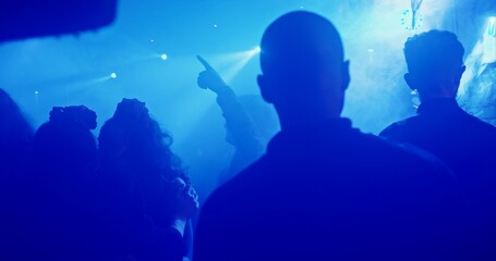 A vibrant nightclub scene with dynamic lighting and a lively crowd dancing enthusiastically