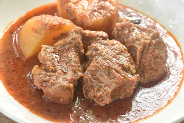 beef curry or Mussamun Indian food with slice potato on plate 