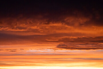 Vibrant sunrise sky with orange and red clouds