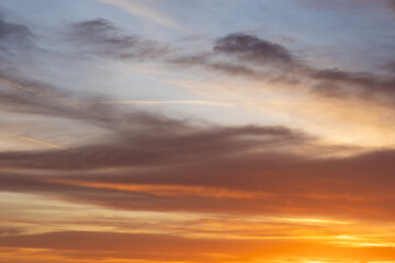 soft blue sky with orange clouds at dawn