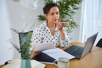 Freelance Designer Working Remotely From Home Using Laptop and Smartphone