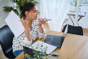 Young Woman Working Remotely in a Home Office Setting with Laptop