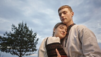 A Young Couple Dressed in Beautiful Traditional Attire Embracing Each Other Outdoors