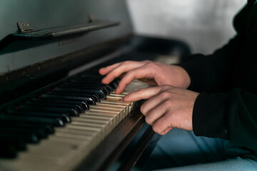 Fototapeta premium Hands gracefully playing the piano, capturing the essence of music, creativity, and artistic expression in a close-up shot