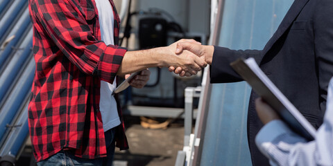 Sustainable Energy and Partnership. Two professionals shaking hands during a solar panel installation meeting, showcasing collaboration in renewable energy.