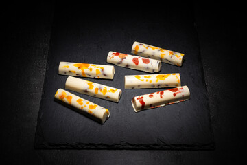 white chocolate bars with salted almonds, on dark background