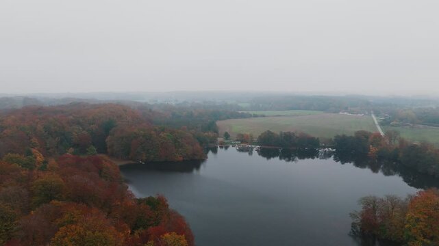 Gyllebo lake in South Sweden, Sk&aring;ne, &Ouml;sterlen at Autumn with yellow and orange leafs, fog