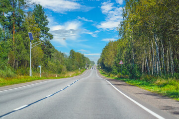 Fototapeta premium Asphalt road rural around forest wooden on a sunny day