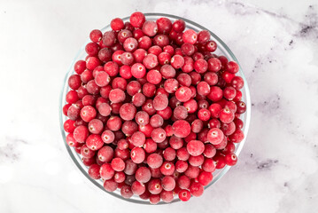 bowl of frozen cranberries on light background. Preservation of vegetables and fruits. Natural products