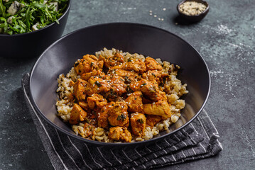 chicken in curry sauce with rice and sesame seeds