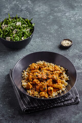 chicken in curry sauce with rice and sesame seeds