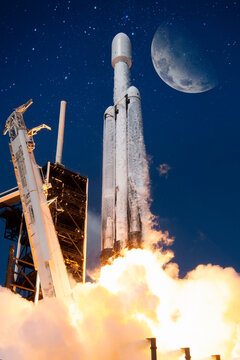 rocket lunch A SpaceX Falcon Heavy rocket carrying NASAs Europa Clipper spacecraft lifts with moon backgroung elements of this image furnished by nasa