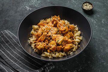 chicken in curry sauce with rice and sesame seeds