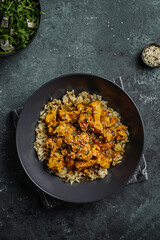 chicken in curry sauce with rice and sesame seeds