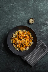 chicken in curry sauce with rice and sesame seeds