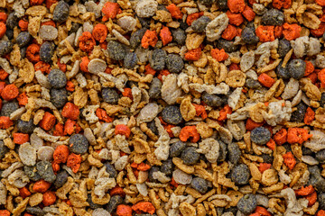 Aquarium fish fodder closeup.Food multicolored for animals and aquarium fish in grits.Top view