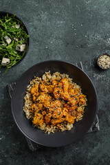 chicken in curry sauce with rice and sesame seeds