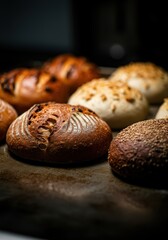 Freshly baked artisan bread rolls with a variety of textures and toppings