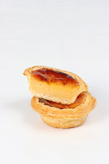 Pasteis de nata, a small Portuguese pastry, a custard tart in a flaky puff pastry, on a white background