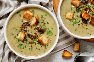 Creamy champignon soup with croutons.top veiw