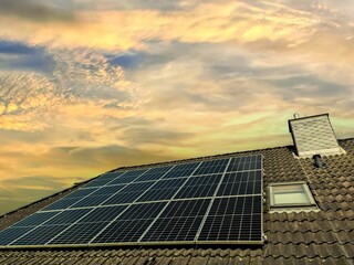 Solar panels producing renewable energy on a rooftop at sunset