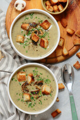 Creamy champignon soup with croutons.top veiw
