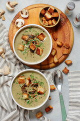 Creamy champignon soup with croutons.top veiw