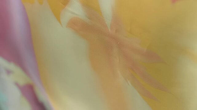 Fabric with beautiful colorful flora patterns flutters in the wind. Closeup. Macro. Closeup. Macro. Slow mo, slow motion, high speed camera, 200fps