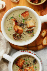 Creamy champignon soup with croutons.top veiw