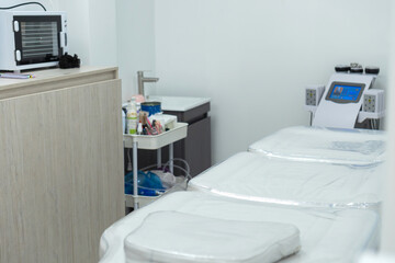 Modern aesthetic clinic showing equipment and treatment beds ready for patients