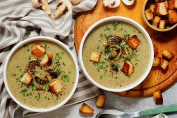 Creamy champignon soup with croutons.top veiw