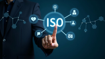 Hand interacting with holographic ISO standards interface showing quality assurance compliance certification icons representing business technology and quality management concepts in empty space conce