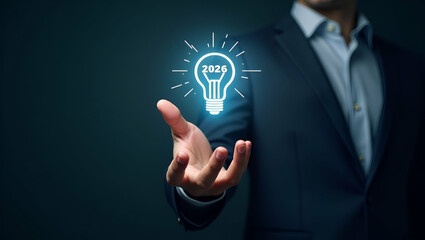 Hand Interacting with Holographic 2026 Business Goals Interface: Lightbulb and Target Symbol for Future Strategies and Action Plans in Empty Space Concept - Stock Photo