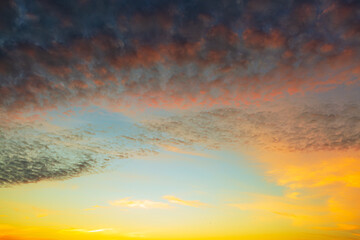 Fototapeta premium Clouds and evening sky,Beautiful sky background - Sunset Sunrise sky with light clouds and real sun,Beautiful dramatic scenic sunset sky background