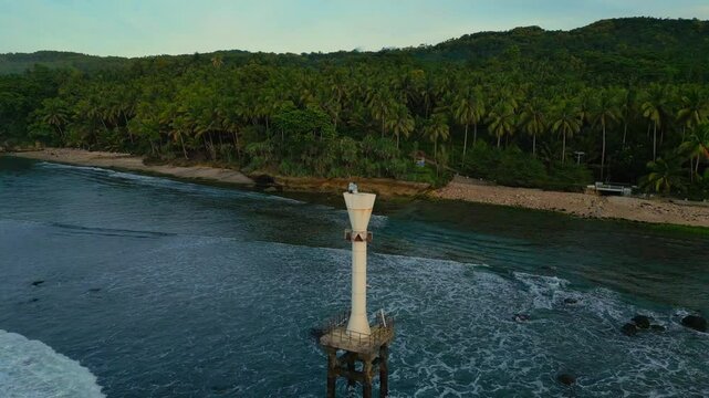 Beautiful drone aerial view of beached around Pacitan with greenery coast under blue cloudy sky