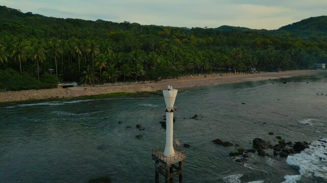 Beautiful drone aerial view of beached around Pacitan with greenery coast at sunset