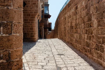 Fototapete Rund Enge Straßen One of the ancient paved narrow historic streets in Old Jaffa on a sunny summer day. Israel.  © Renar