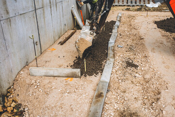 Construction site activity with digging machine working on foundation preparation