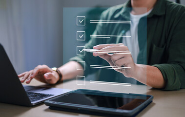 assessment survey online. Businessman with evaluating questionnaire on online laptop computer. choose correct answer in test, questions test, online exam, quiz knowledge, filling out an survey form.