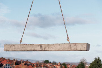 Heavy concrete beam suspended by chains 